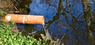 Water going into lake through tube